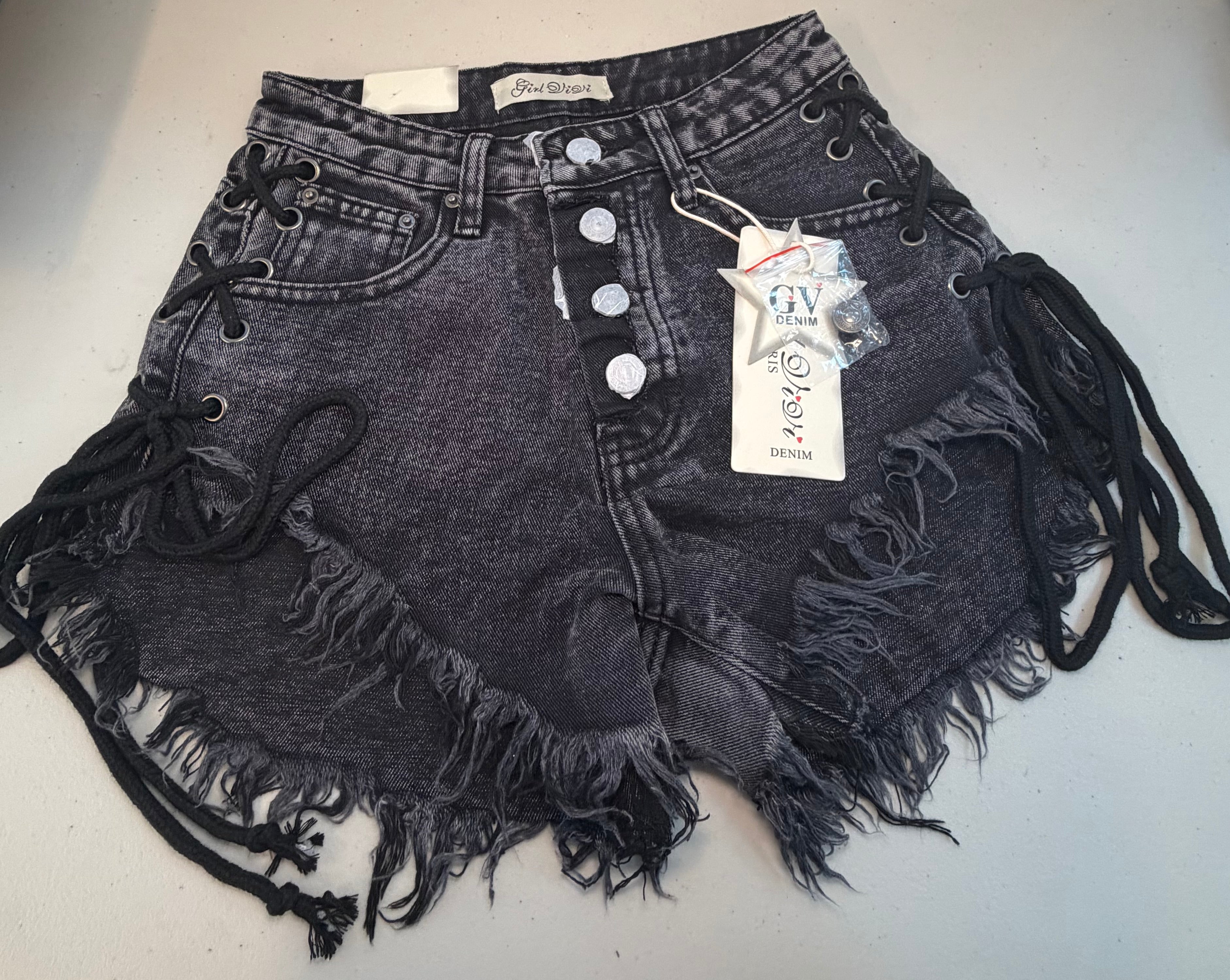 PARIS- Denim shorts with black ties.