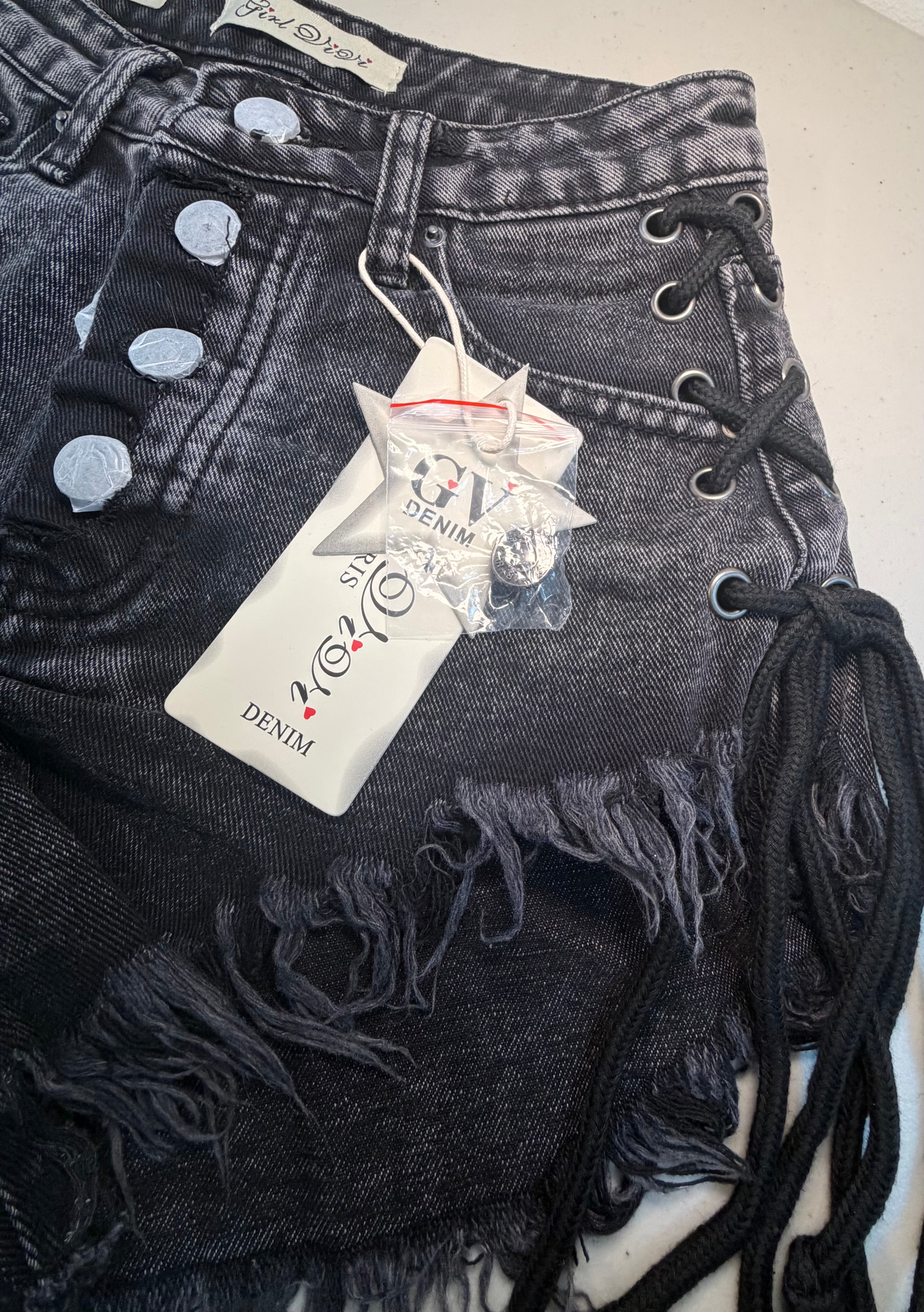 PARIS- Denim shorts with black ties.