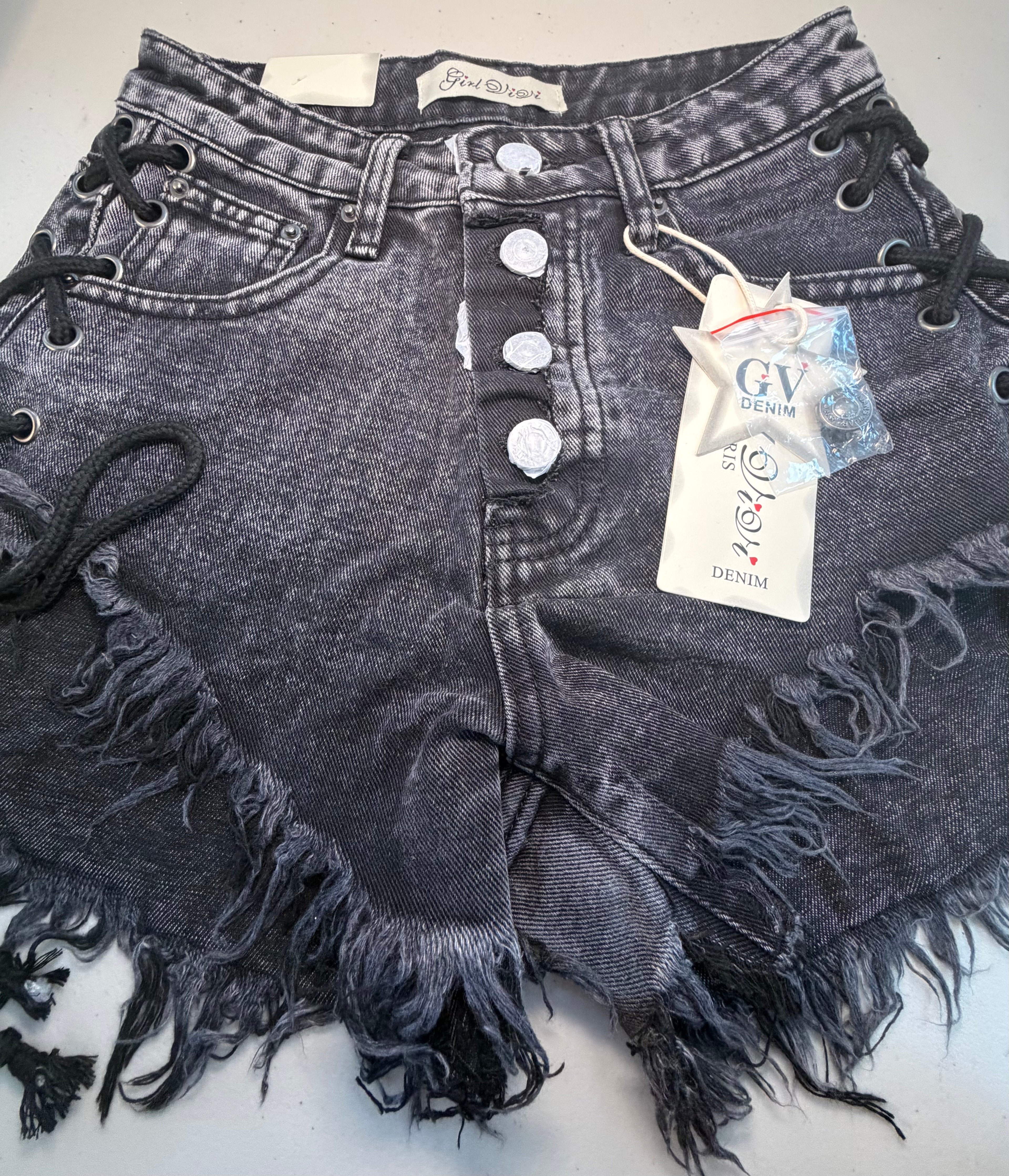 PARIS- Denim shorts with black ties.