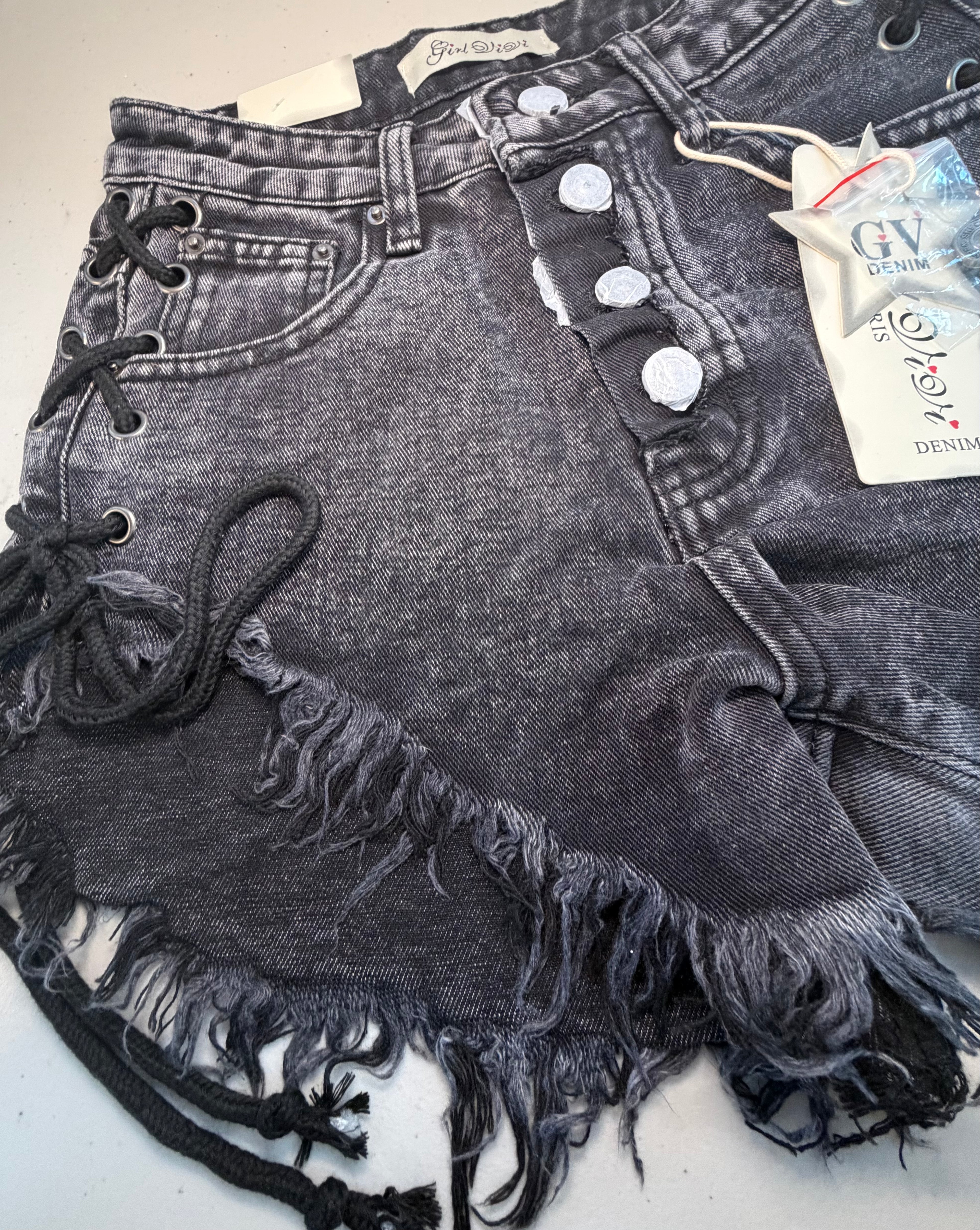 PARIS- Denim shorts with black ties.