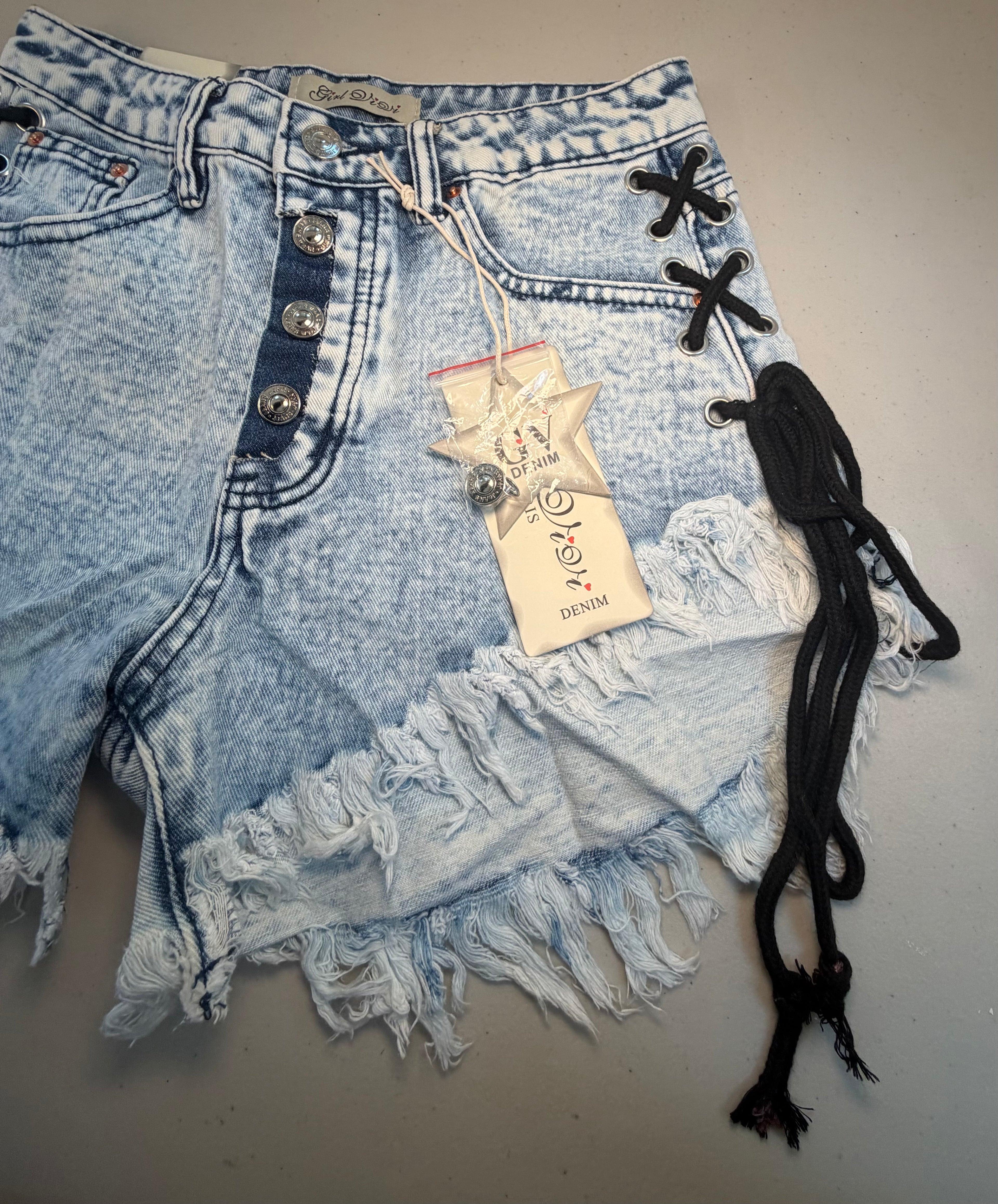 PARIS- Denim shorts with black ties.