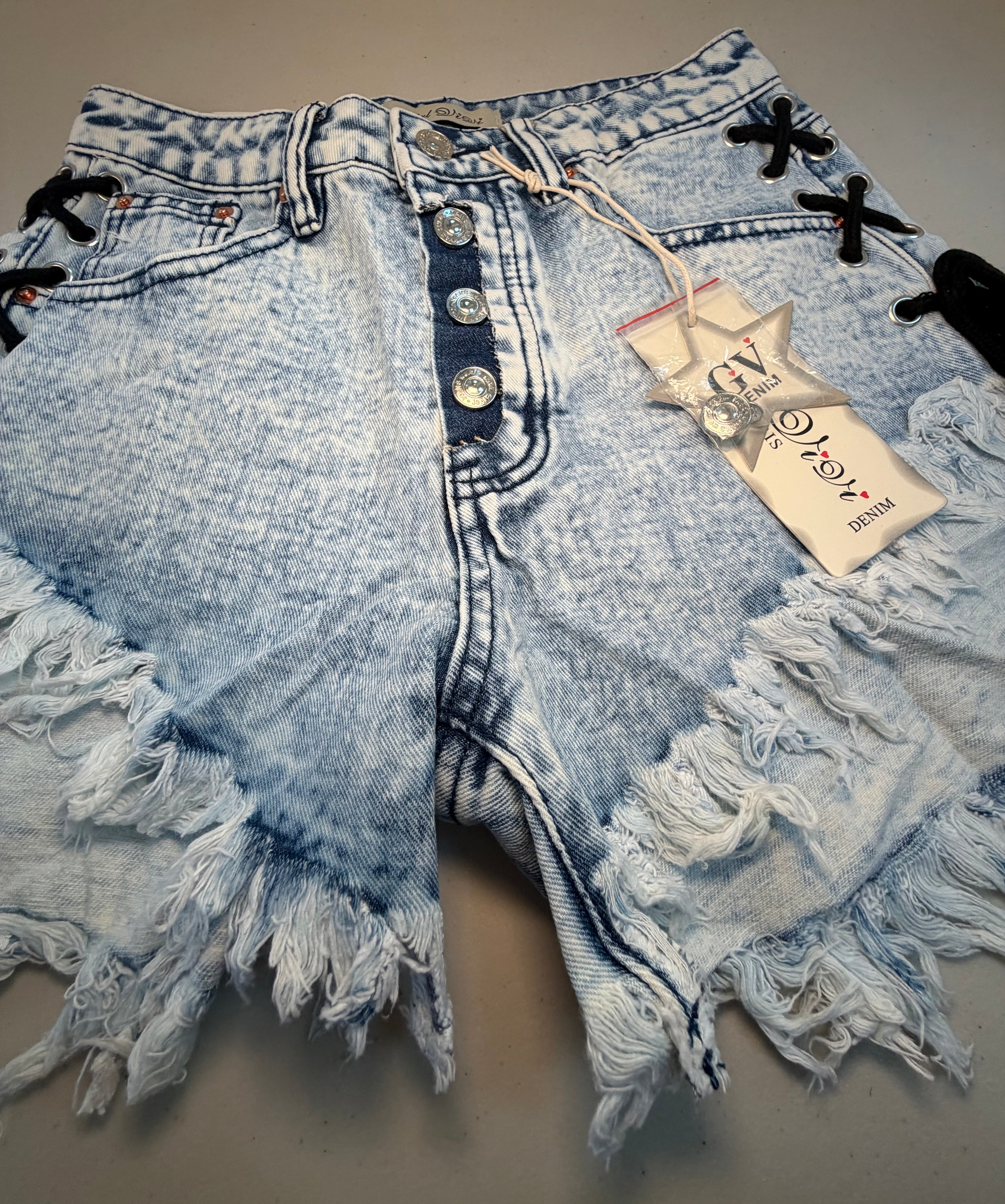 PARIS- Denim shorts with black ties.