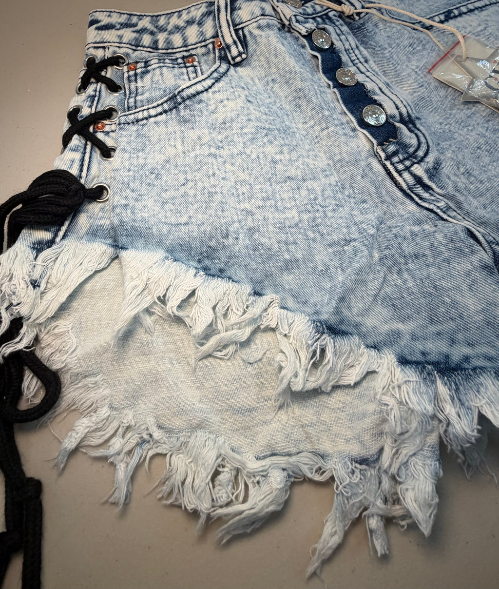 PARIS- Denim shorts with black ties.